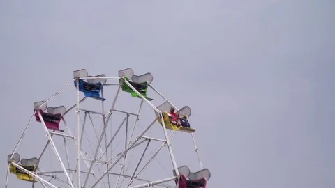 Ferris wheel against gray sky, depressing carnival Stock Footage 84319446