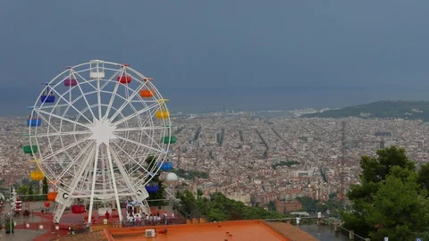 Ferris Wheel against gray sky and beautiful Barcelona panorama Stock Footage 99658096