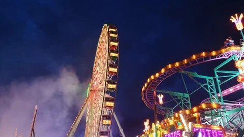 Ferris wheel and carousel by night in Germany,Bad Durkheim,on Wurstmarkt fest Stock Footage 115775689