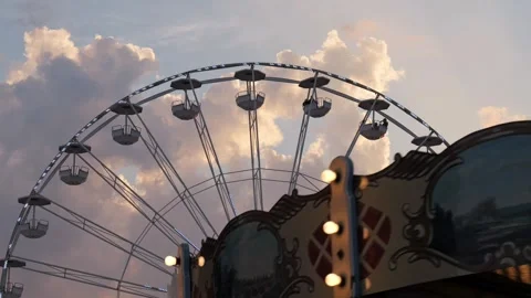 Ferris wheel and carousel spinning at sunset amusement park 스톡 동영상 340280538