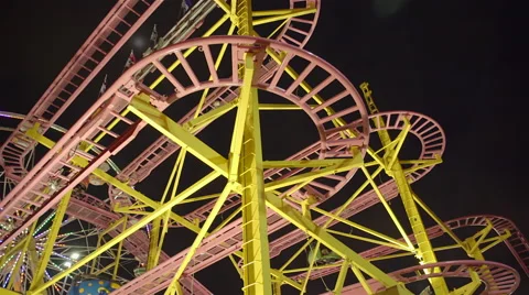 Ferris wheel and roller coaster at amusement park at night. 4K UHD. Stock Footage 54299836