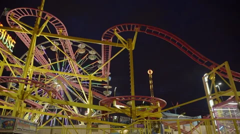 Ferris wheel and roller coaster at amusement park at night. 4K UHD. Stock-Footage 54302871