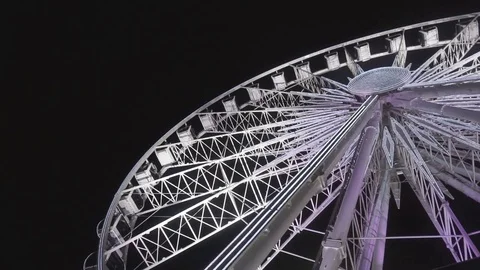 Ferris wheel and rollercoaster in motion at amusement park at night Stock-Footage 69754111
