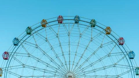 Ferris wheel with an array of vibrant and colorful capsules. 스톡 사진