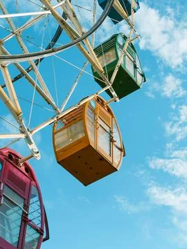 Ferris wheel with an array of vibrant and colorful capsules. Stock Photos