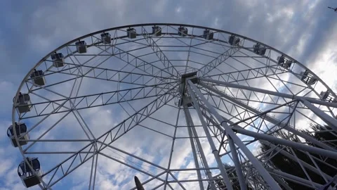 Ferris wheel on a background of blue sky and clouds. Entertainment park Video stock 194383476