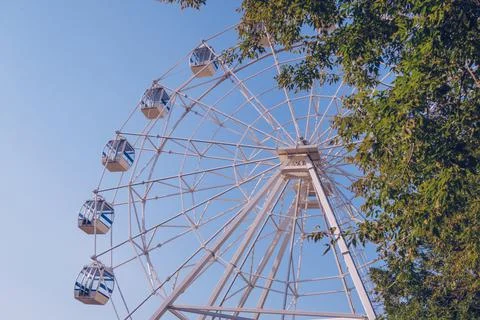 Ferris wheel on the background of the blue sky. Amusement park, fair, no peop Stock Photos