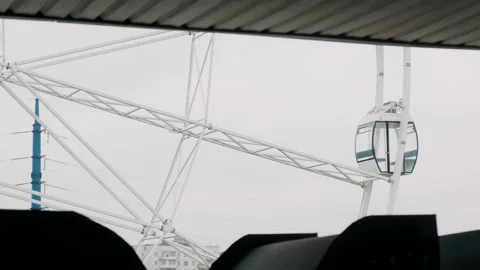  Ferris wheel with cabins visible from the window Stock Footage 261664446