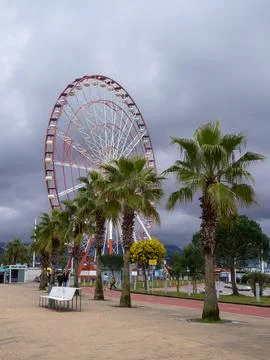 Ferris wheel on a cloudy day. Cloudy sky. Ferris wheel in an amusement park.. Stock Photos