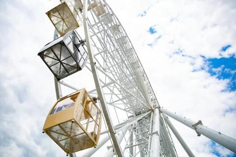 Ferris wheel on cloudy sky background Stock Photos