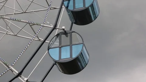 Ferris wheel in cloudy weather close up Stock Footage 77560732