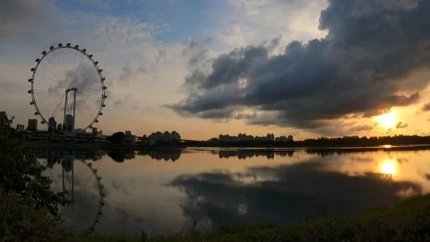 Ferris Wheel during Sunrise/Sunset with Reflection on River Stock Footage 156653450