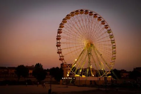 Ferris wheel in the evening with a sunset Stock Photos
