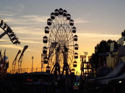 Ferris Wheel In Front Of Sunset Stock Photos