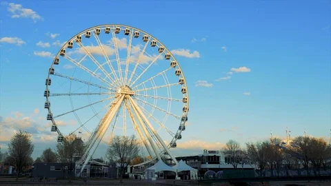 Ferris wheel (Grande Roue ) found in the Old Port of Montreal at sunset Stock Footage 107739076