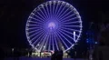 Ferris Wheel with great illumination at Christmas fair and people HD Footage