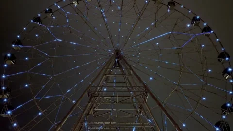 Ferris wheel with illustrations on the background of the night sky Stock Footage 260837397