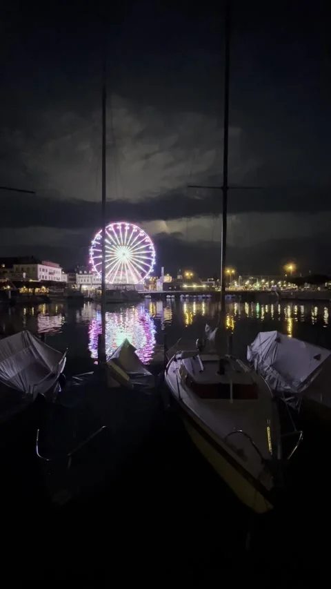 Ferris wheel by the lake, lightning in the background Stock Footage 255302532