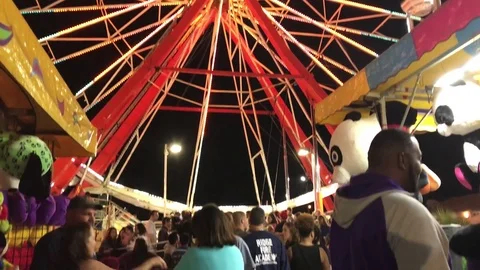 Ferris wheel lighting up at fair Stock-Footage 73430995
