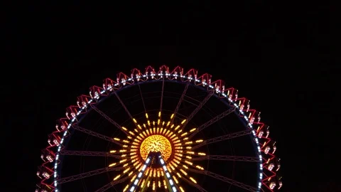Ferris wheel lights on black background at night Stock Footage 125908619