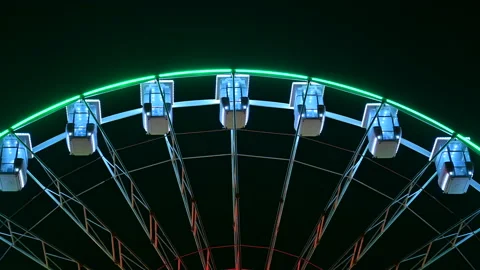 Ferris wheel with multi-colored illumination against night sky Stock Footage 171592840