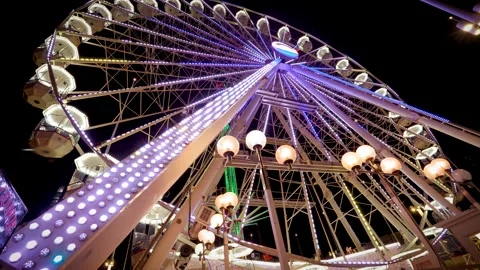 Ferris Wheel at night rotating slowly dynamically illuminated Stock Footage 223785758