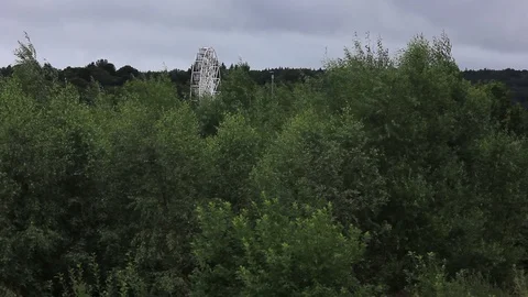 Ferris wheel over looking trees cloudy Stock Footage 93894929