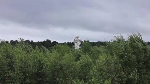 Ferris wheel over looking trees static Stock Footage 93896037
