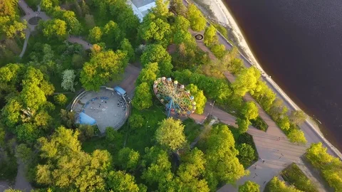 The Ferris wheel in the park on the bank of the river from a bird's eye view Stock Footage 89998628