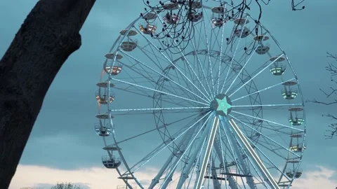 Ferris wheel. People having fun riding roller coaster at the amusement park Stock Footage 238031578