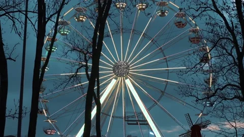 Ferris wheel. People having fun riding roller coaster at the amusement park Stock Footage 238031595