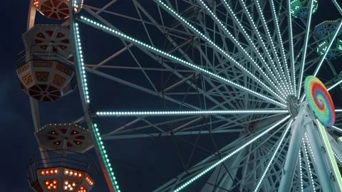 Ferris wheel. People having fun riding roller coaster at the amusement park Stock Footage 238031598
