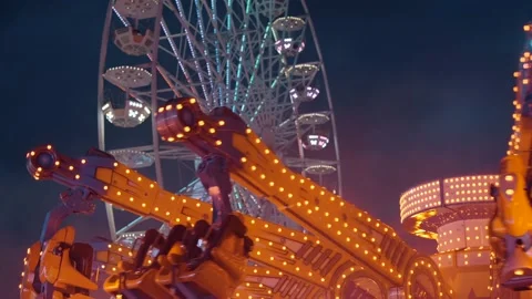 Ferris wheel. People having fun riding roller coaster at the amusement park Stock Footage 238031603