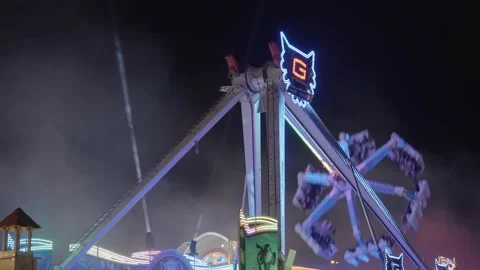 Ferris wheel. People having fun riding roller coaster at the amusement park Stock Footage 238031627