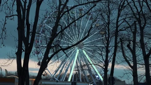Ferris wheel. People having fun riding roller coaster at the amusement park Stock Footage 238530426