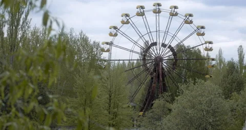 The Ferris wheel in Pripyat behind trees Stock Footage 200835939