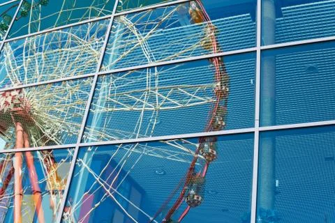Ferris wheel reflected in the window Stock Photos