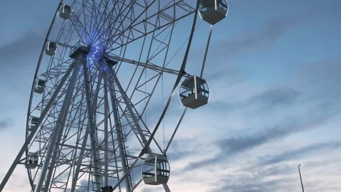 Ferris wheel rotates against the background of the dusk sunset sky Stock Footage 219920007