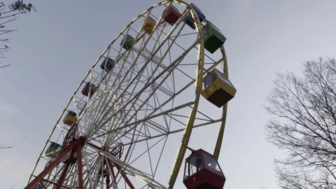 A ferris wheel rotates against the background of the evening sky Stock Footage 221024735