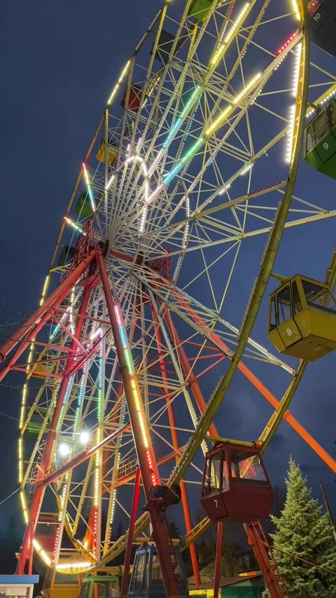 A ferris wheel rotates against the background of the night sky. Stock Footage 221964602