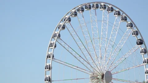 Ferris wheel rotates on blue sky background 4k Stock Footage 53174283