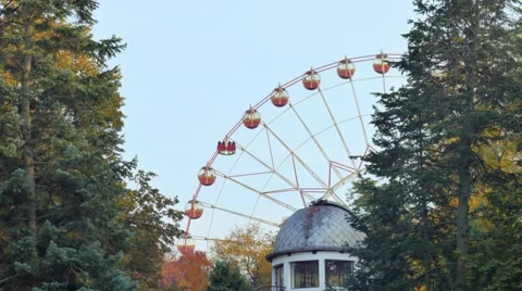 Ferris wheel rotates in a park in the foreground roof observatory Stock Footage 68645537