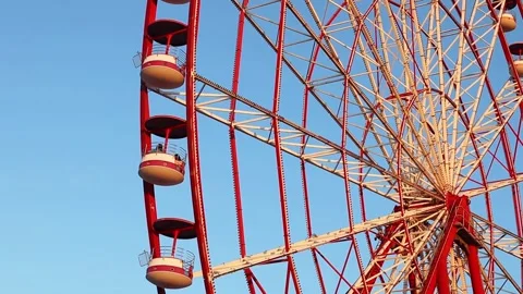Ferris Wheel rotating against blue sky Stock Footage 279001208
