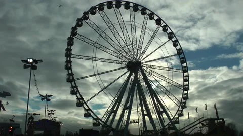 Ferris wheel silhouetted against dramatic sky Stock Footage 47108090