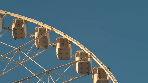 Ferris Wheel Slowly Rotating in Daylight Stock Footage 321637202