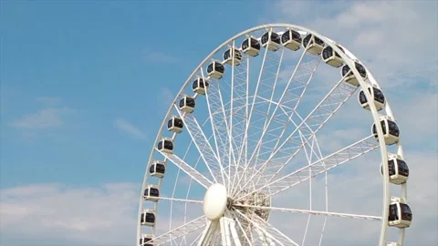 Ferris wheel spinning during the day in the blue sky Stock Footage 213915224