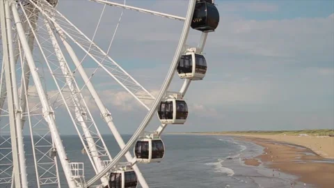 Ferris wheel spinning during the day in a scevening blue sky Stock Footage 213916081