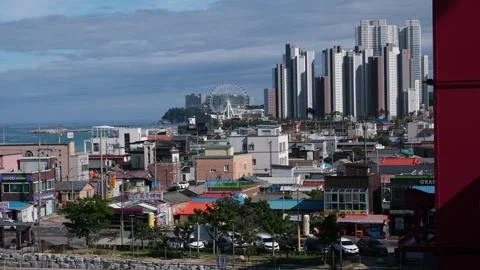 Ferris wheel stands against the backdrop of tall high-rise buildings on the Video stock 341568849