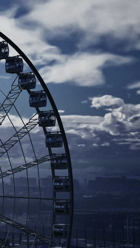Ferris wheel stands against clouds during evening light in the city Stock Footage 338344584