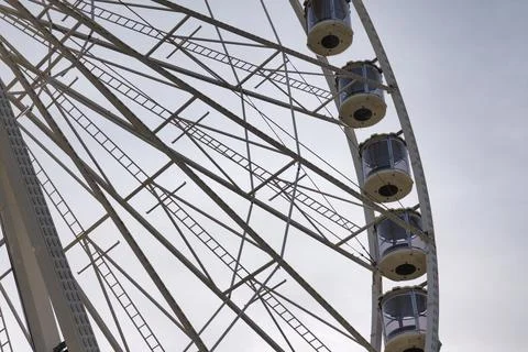 Ferris wheel structure view with cabins during daytime at a fairground Stock Photos